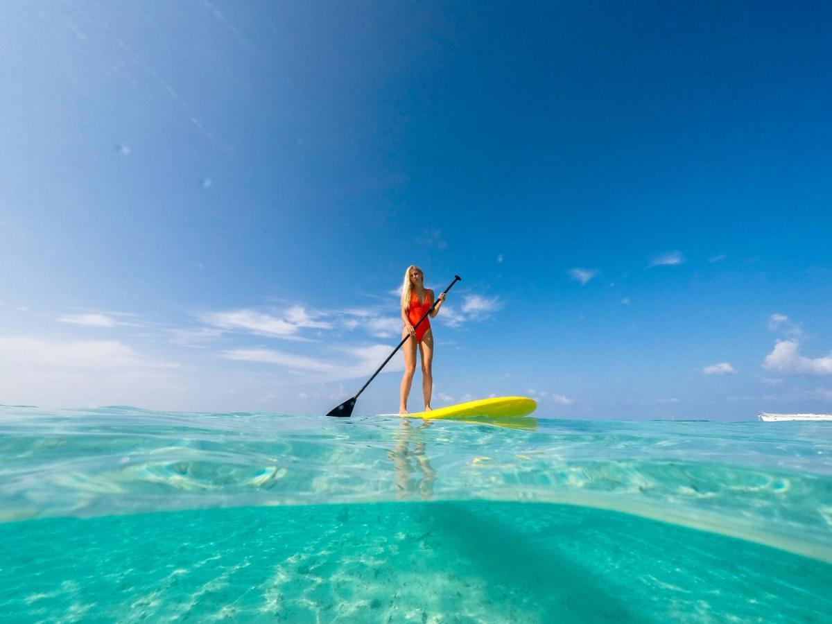 Malahini Kuda Bandos Resort Hulhumale Esterno foto Stand-up paddle boarder in the Maldives